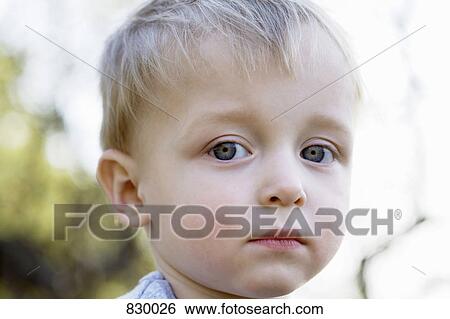 Portrait of a young boy looking sad View Large Photo Image Stock Photograph - Portrait of a young boy looking sad. Fotosearch