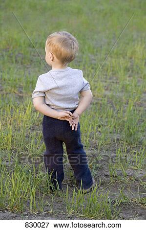 Portrait of a young boy, rear view, outdoors View Large Photo Image Stock Photo - Portrait of a young boy, rear view, outdoors. Fotosearch