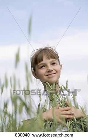 Portrait of a young girl in a wheat field View Large Photo Image Stock Image - Portrait of a young girl in a wheat field. Fotosearch