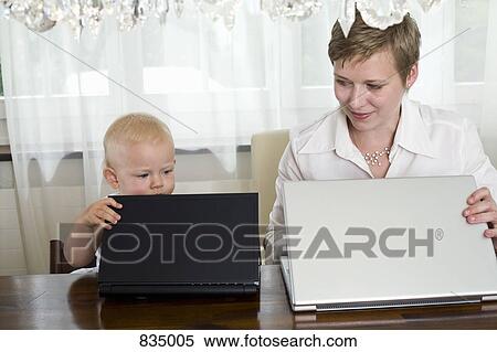 A mother and toddler opening their laptops, side by side View Large Photo Image Stock Photography - A mother and toddler opening their laptops, side by side. Fotosearch