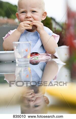 Stock Image - A toddler eating. Fotosearch