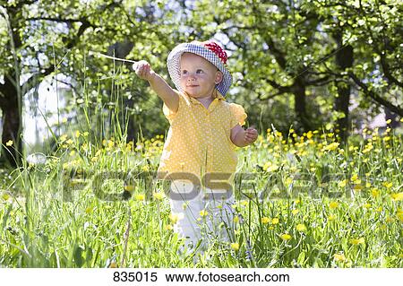 A toddler in standing amongst wildflowers View Large Photo Image Stock Photography - A toddler in standing amongst wildflowers. Fotosearch