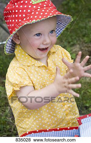 Stock Photo - Portrait of a toddler clapping, close-up. Fotosearch