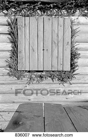 Decorated window of a wooden cabin View Large Photo Image Stock Photo - Decorated window of a wooden cabin. Fotosearch