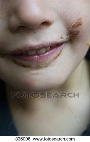 Stock Photograph - Detail of a boy with food around his mouth. Fotosearch