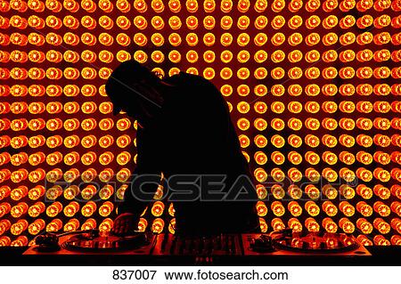 A DJ playing records at nightclub View Large Photo Image Stock Photo - A DJ playing records at nightclub. Fotosearch