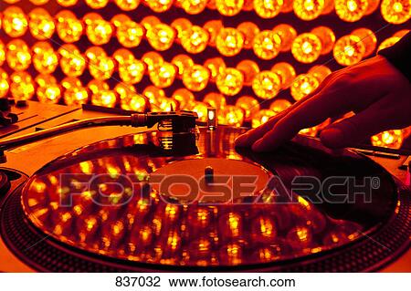 A DJ scratching a record at a nightclub View Large Photo Image Stock Image - A DJ scratching a record at a nightclub. Fotosearch