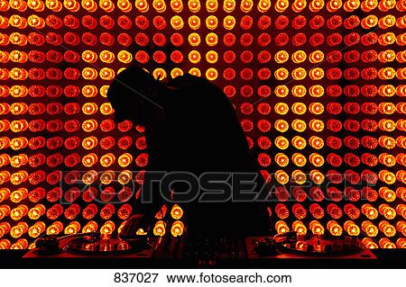 A DJ scratching a record in a nightclub View Large Photo Image Stock Photo - A DJ scratching a record in a nightclub. Fotosearch