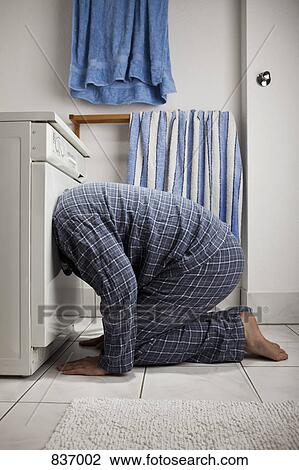 A man wearing pajamas with his head inside a washing machine View Large Photo Image Stock Image - A man wearing pajamas with his head inside a washing machine. Fotosearch