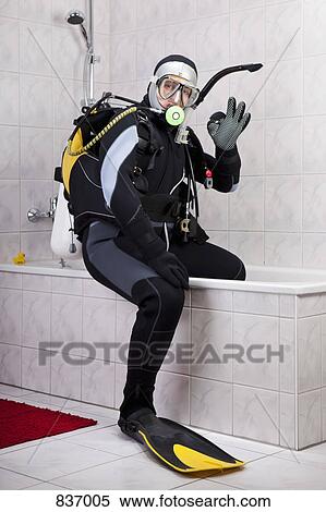 A scuba diver making the OK sign while sitting on the edge of a bathtub View Large Photo Image Stock Photography - A scuba diver making the OK sign while sitting on the edge of a bathtub. Fotosearch