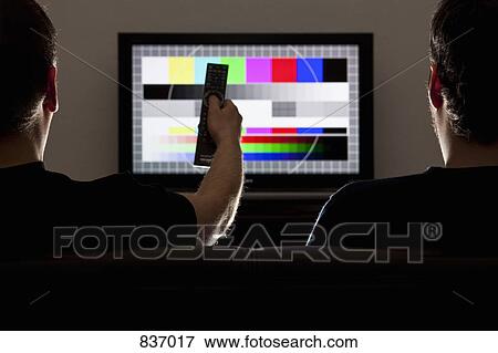 Two men watching a test pattern on a television View Large Photo Image Stock Photo - Two men watching a test pattern on a television. Fotosearch
