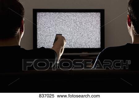 Two men watching static on television View Large Photo Image Stock Photography - Two men watching static on television. Fotosearch