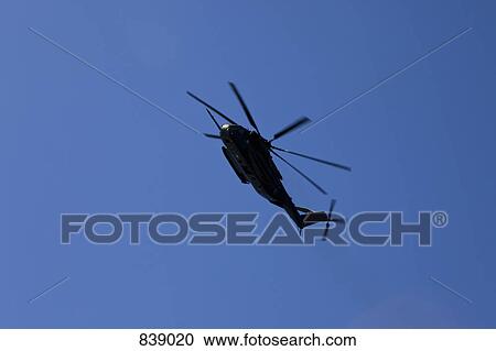 Stock Image - Helicopter flying in the sky. Fotosearch