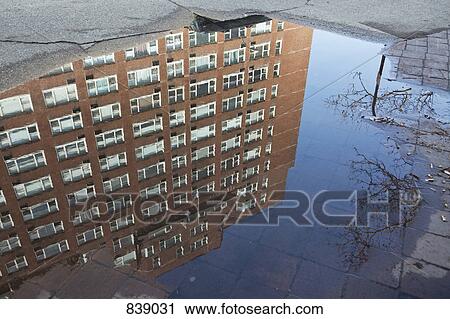 Puddle with reflection of a building View Large Photo Image Stock Image - Puddle with reflection of a building. Fotosearch