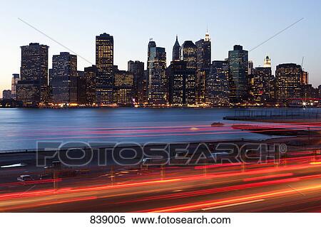 Stock Photography - Traffic and cityscape at dusk, Manhattan, New York City, NY, USA. Fotosearch