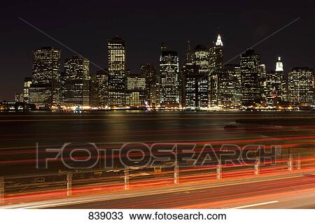Stock Image - Traffic and cityscape at night, Manhattan, New York City, NY, USA. Fotosearch