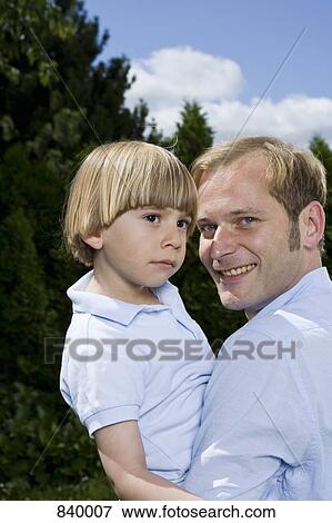 A father holding his son, portrait View Large Photo Image Stock Photo - A father holding his son, portrait. Fotosearch