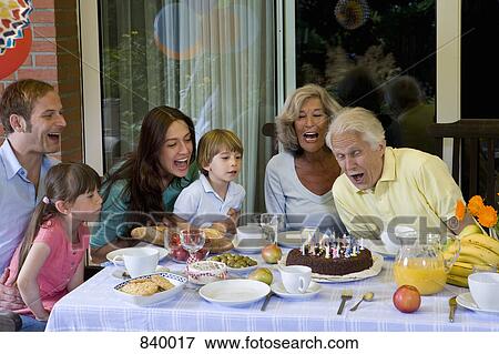A multi-generational family celebrating a birthday, outdoors View Large Photo Image Stock Photo - A multi-generational family celebrating a birthday, outdoors. Fotosearch
