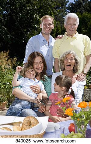 A multi-generational family having breakfast, outdoors View Large Photo Image Stock Photography - A multi-generational family having breakfast, outdoors. Fotosearch