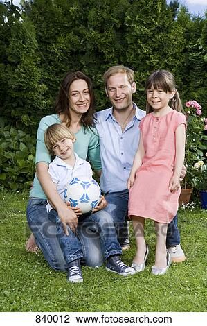 Stock Image - A portrait of a mid adult couple and their two young children. Fotosearch