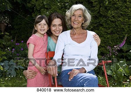 Stock Photo - Portrait of a woman with her daughter and granddaughter. Fotosearch