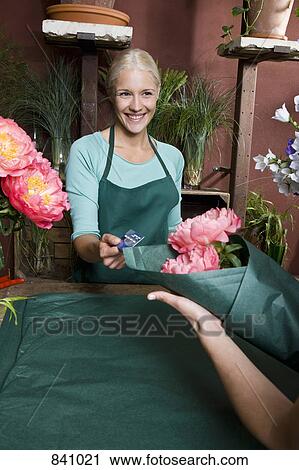 A florist serving a customer View Large Photo Image Stock Image - A florist serving a customer. Fotosearch