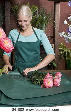 A florist wrapping up a bunch of flowers View Large Photo Image Stock Image - A florist wrapping up a bunch of flowers. Fotosearch