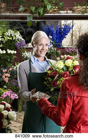 A woman buying flowers in a florist View Large Photo Image Stock Photo - A woman buying flowers in a florist. Fotosearch