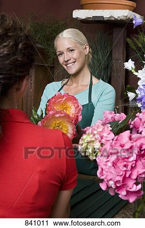 A woman buying flowers in a florists View Large Photo Image Stock Image - A woman buying flowers in a florists. Fotosearch