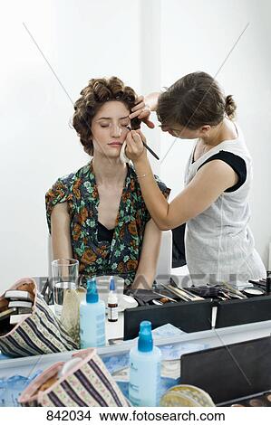 A make-up artist applying make-up on a model View Large Photo Image Picture - A make-up artist applying make-up on a model. Fotosearch