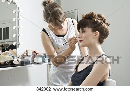 A make-up artist applying make-up on a model View Large Photo Image Stock Image - A make-up artist applying make-up on a model. Fotosearch
