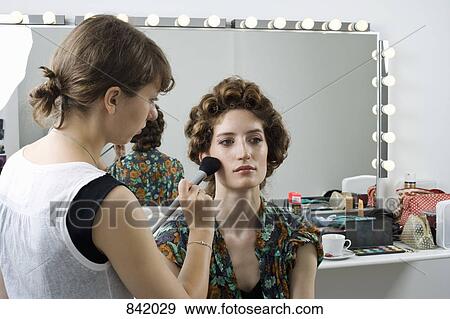A make-up artist applying make-up on a model View Large Photo Image Stock Photo - A make-up artist applying make-up on a model. Fotosearch