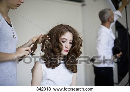 Stock Photo - A model having her hair prepared. Fotosearch