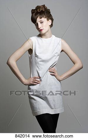 Picture - A young woman posing with hands on hips. Fotosearch
