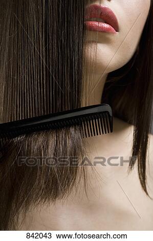 Detail of a teenage girl combing her hair View Large Photo Image Stock Image - Detail of a teenage girl combing her hair. Fotosearch