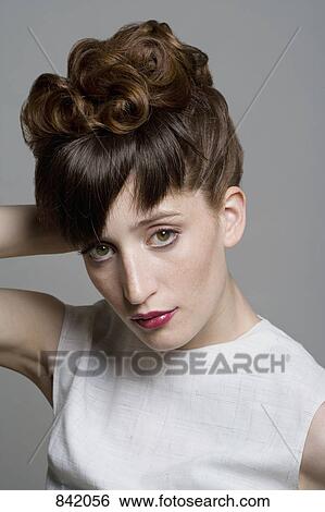 Portrait of a young woman with an elegant hairstyle View Large Photo Image Stock Photograph - Portrait of a young woman with an elegant hairstyle. Fotosearch