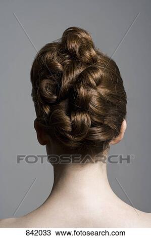 Rear view of a young woman with an elegant hairstyle View Large Photo Image Stock Image - Rear view of a young woman with an elegant hairstyle. Fotosearch