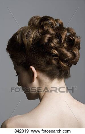Rear view of a young woman with an elegant hairstyle View Large Photo Image Stock Photo - Rear view of a young woman with an elegant hairstyle. Fotosearch