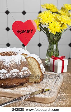 A Bundt cake, flowers and a gift box for Mother's Day View Large Photo Image Stock Image - A Bundt cake, flowers and a gift box for Mother's Day. Fotosearch