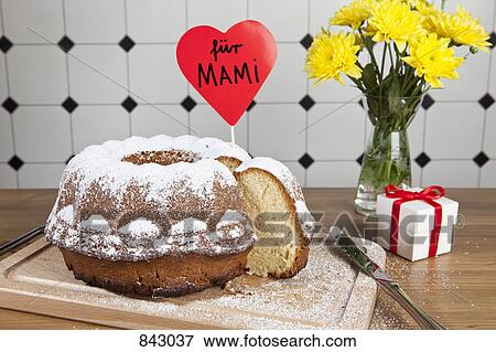 A Bundt cake, flowers and a gift box for Mother's Day in Germany View Large Photo Image Stock Photo - A Bundt cake, flowers and a gift box for Mother's Day in Germany. Fotosearch