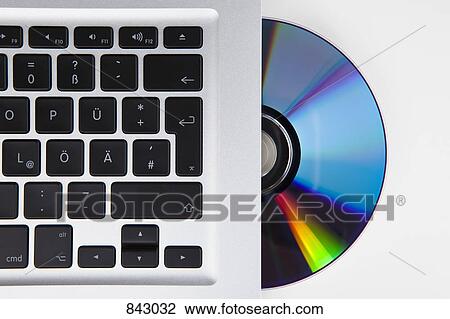 A CD-ROM or DVD halfway in a German laptop View Large Photo Image Stock Image - A CD-ROM or DVD halfway in a German laptop. Fotosearch