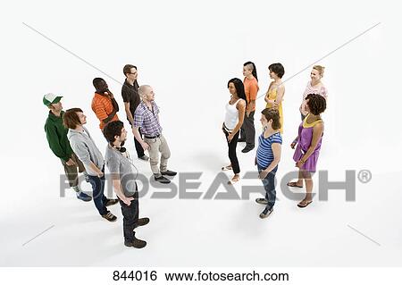 Stock Photograph - A group of men facing a group of women. Fotosearch