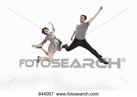 A young man and a young woman jumping mid-air View Large Photo Image Stock Photo - A young man and a young woman jumping mid-air. Fotosearch