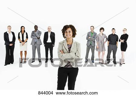 Picture - A young professional standing in front of a row of business people. Fotosearch