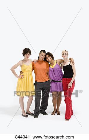 Four young women standing together View Large Photo Image Stock Image - Four young women standing together. Fotosearch