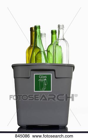 Stock Photograph - A glass recycling bin with bottles sticking out. Fotosearch