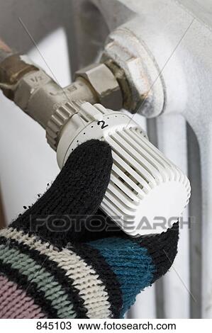 A hand wearing a mitten turning the knob of a radiator View Large Photo Image Stock Image - A hand wearing a mitten turning the knob of a radiator. Fotosearch