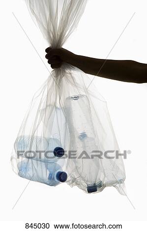 A human hand holding a transparent garbage bag of plastic bottles View Large Photo Image Stock Image - A human hand holding a transparent garbage bag of plastic bottles. Fotosearch