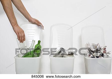 A human hand putting a glass jar in a recycling bin View Large Photo Image Stock Photograph - A human hand putting a glass jar in a recycling bin. Fotosearch
