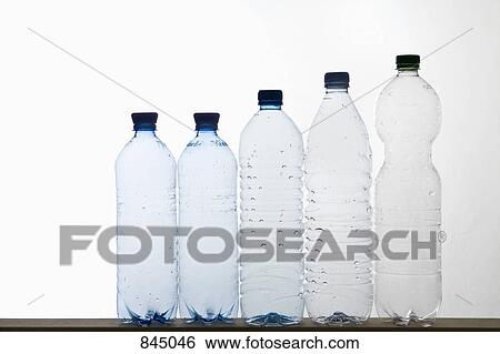 A row of plastic water bottles View Large Photo Image Stock Photograph - A row of plastic water bottles. Fotosearch